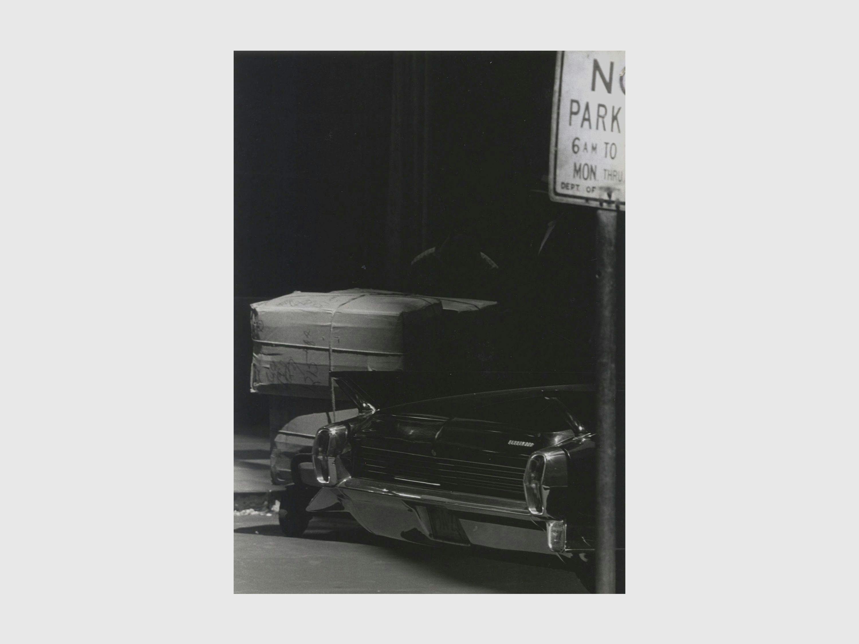 A photograph by Roy de Carava titled Two men boxes and car, dated 1966.
